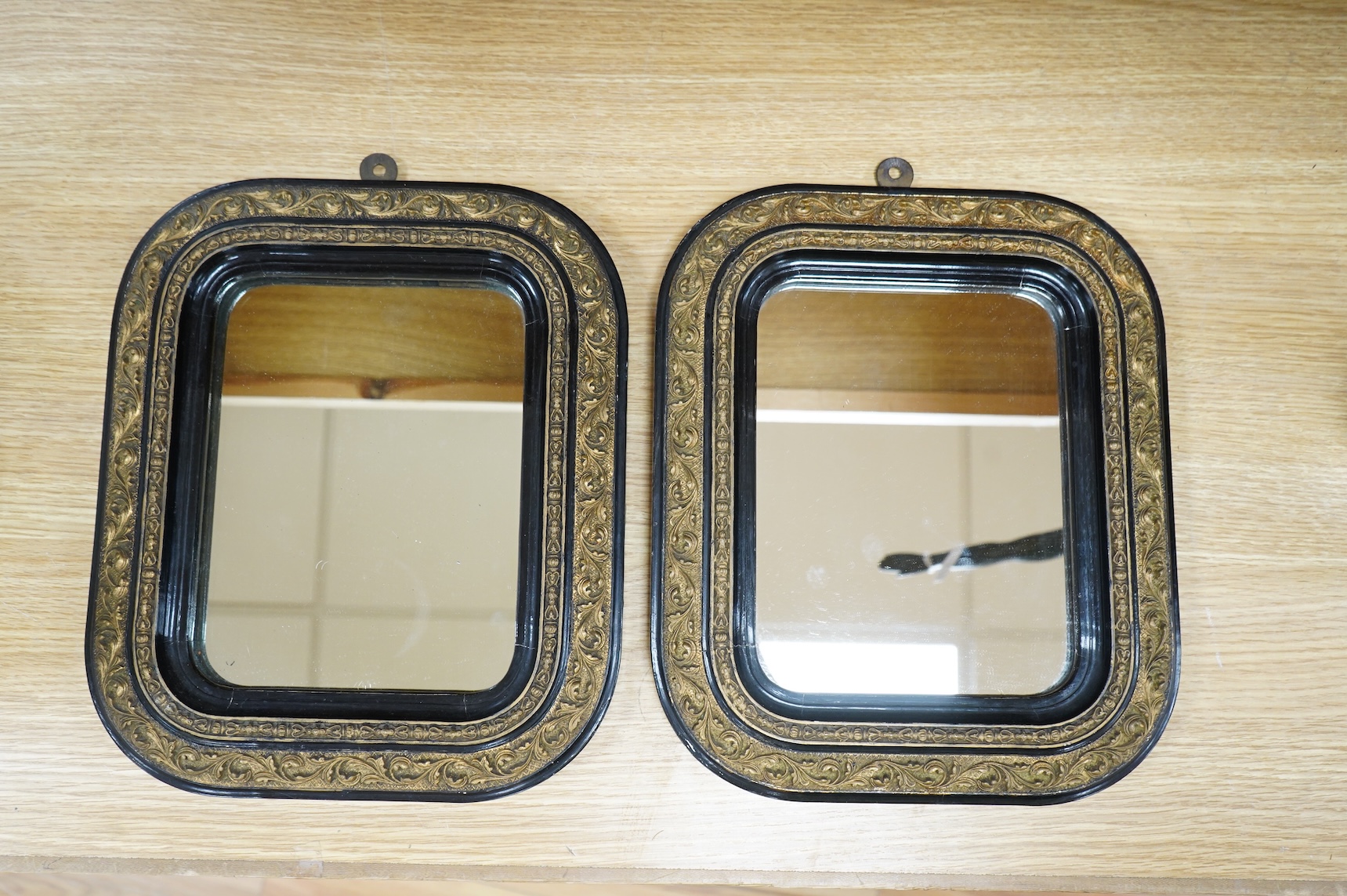 A pair of 19th century French ebonised and gilt wall mirrors, 32 x 27cm